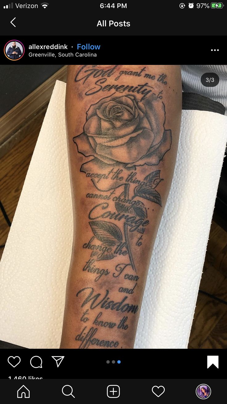 a person with a rose tattoo on their leg and some words written in the background