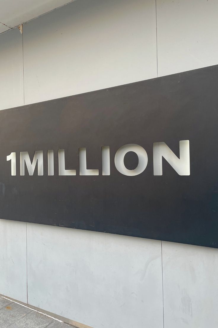 there is a sign that says 1 million on the side of a building in front of it