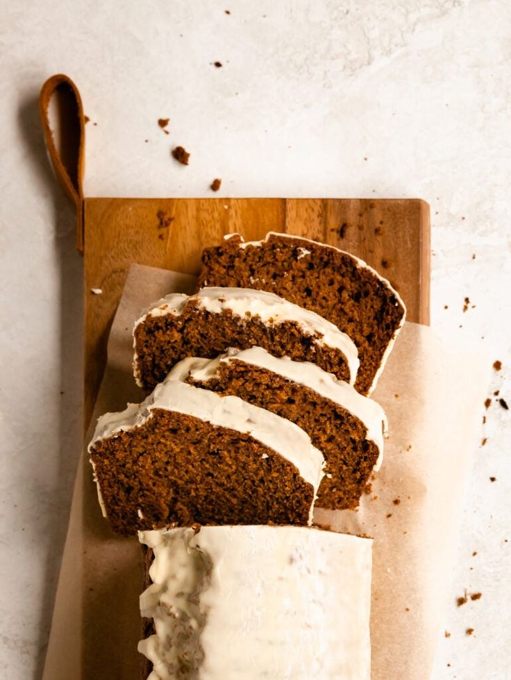 sliced loaf of carrot bread with cream cheese frosting