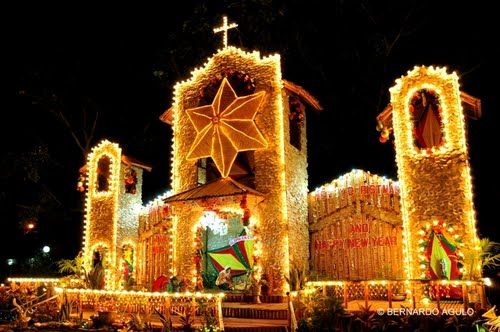 a church covered in christmas lights at night with decorations on the front and side walls