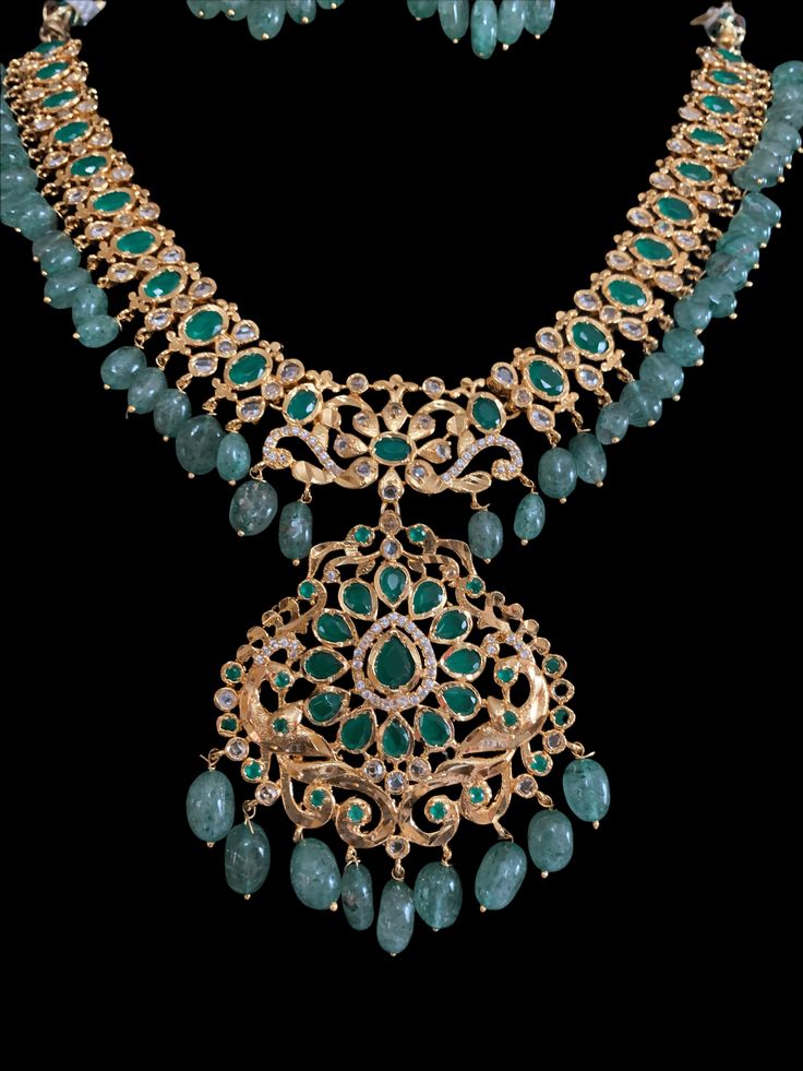 necklace with earrings made using real emerald beads Cz stones used gold plated Gold Bridal Necklace With Emerald Gemstone, Elegant Emerald Jewelry Sets With Stone Work, Elegant Emerald Jewelry With Stone Work, Gold Emerald Bridal Necklace With Gemstones, Hand Set Emerald Necklaces For Festive Occasions, Hand Set Emerald Necklace For Festive Occasions, Green Emerald Kundan Necklace With Gemstones, Exquisite Green Emerald Necklace With Jewels, Green Jeweled Temple Jewelry Necklace