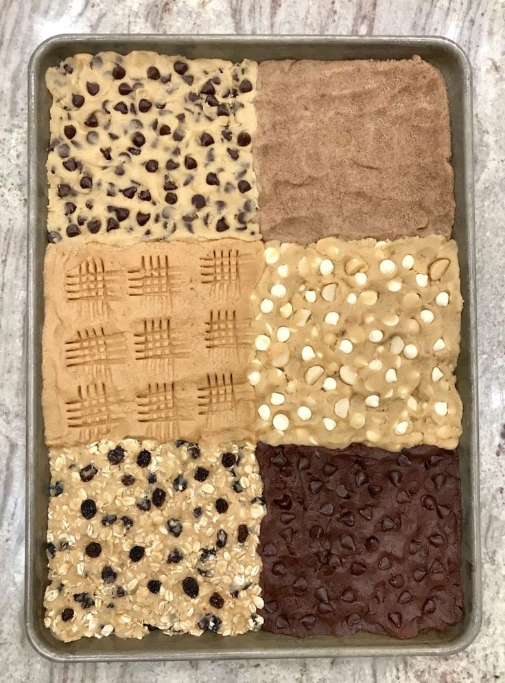 a pan filled with lots of different types of cookies and bars on top of a counter