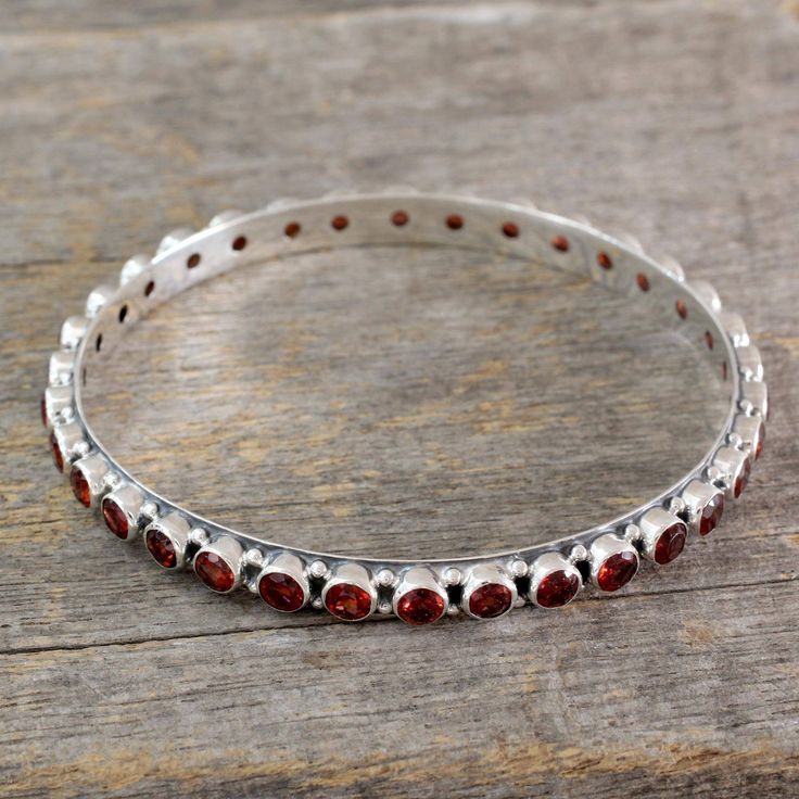 Garnet gem of love and passion shares its crimson energy in the cheerful design of this bangle from India. From Bhavesh the sterling silver bracelet is crafted with a high polished finish and 15 gemstone carats. .925 Sterling silver Silver Bangles Design, Uk Christmas, Black Beads Mangalsutra, Sterling Silver Promise Rings, Gold And Silver Bracelets, Silver Bangle Bracelet, Bangles Design, Womens Earrings Studs, Garnet Bracelet