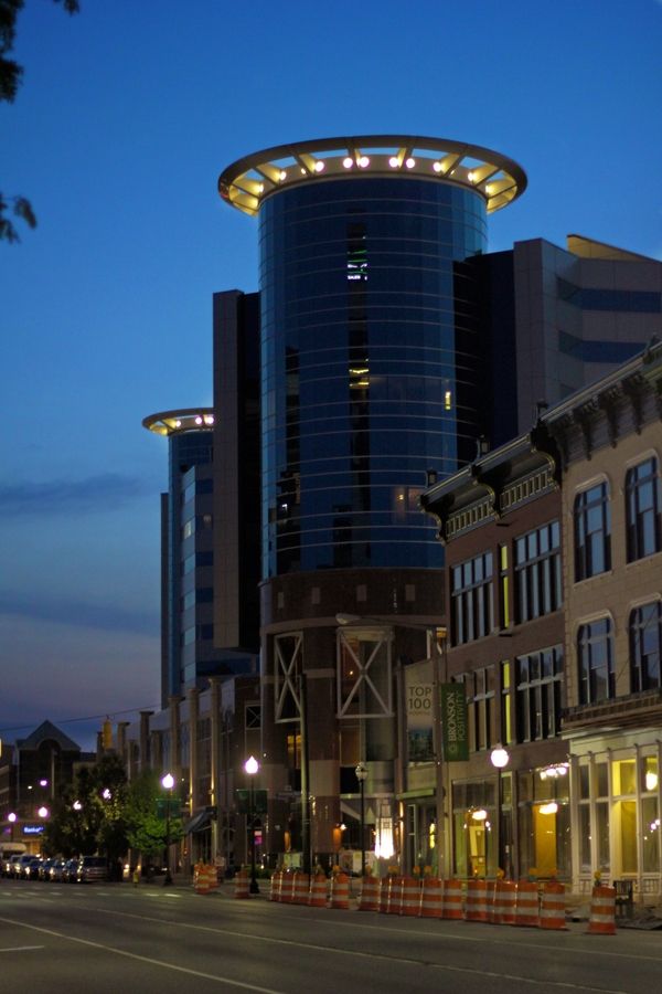 an empty city street at night with tall buildings