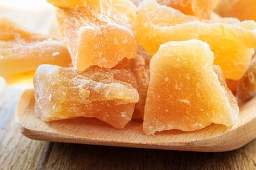 pieces of fruit sitting on top of a wooden plate