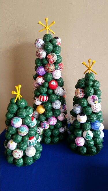 three small christmas trees made out of balls