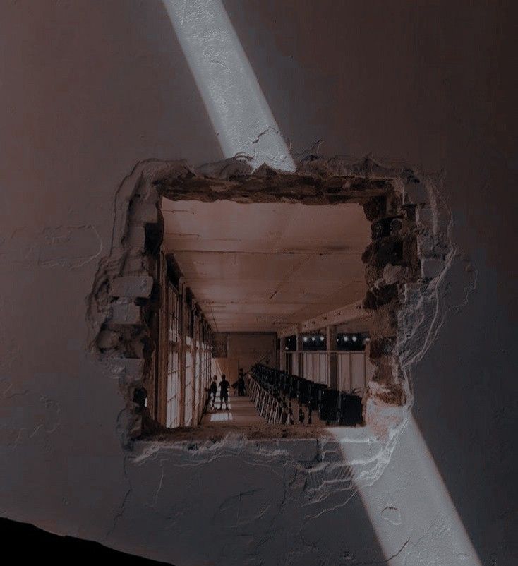 an open window in the side of a wall with people walking down it and sunlight coming through