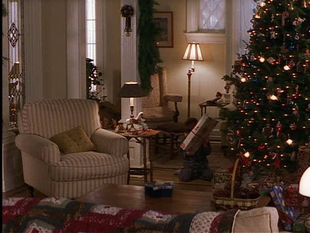 a living room with a christmas tree in the corner