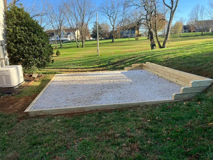 an empty concrete slab in the middle of a yard