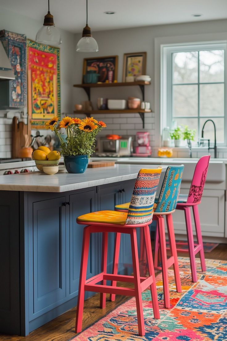 three colorful stools sit in the middle of a kitchen