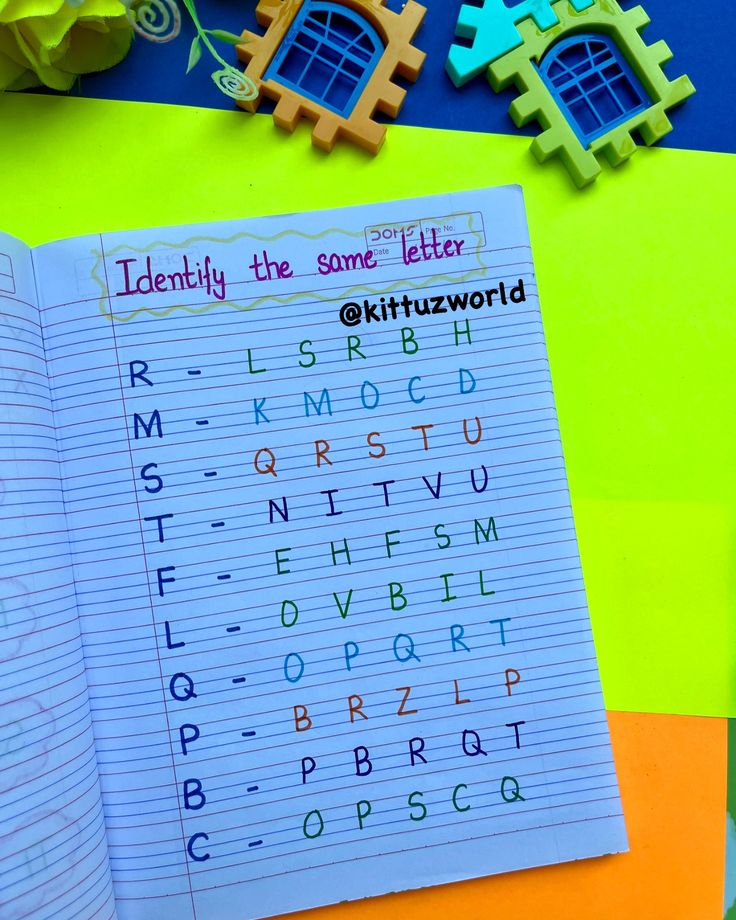 an open notebook with letters and numbers on it