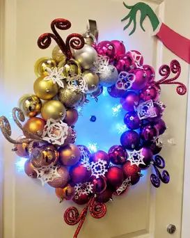 a christmas wreath is hanging on the front door