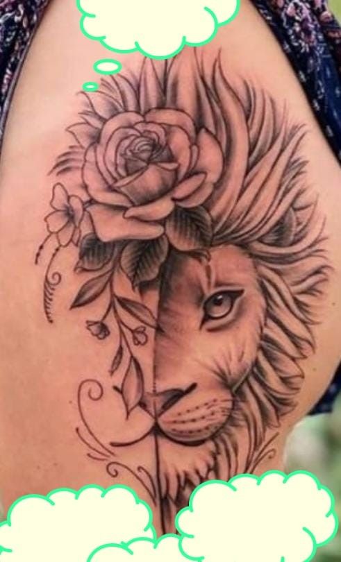 a woman's thigh with a lion and rose tattoo on it