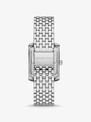 Side panels of understated pavé crystals add shine to the rectangular face of our petite Emery watch. The polished beveled strap is made of silver-tone stainless steel, while the iridescent blue dial features Roman numeral indexes for a luxurious finish. Glamorous enough to pair with evening looks yet understated enough to complement a simple T-shirt and jeans, this is a timeless style you’ll never want to take off. Silver Square Watch With Metal Dial, Timeless Silver Square Watch, Elegant Silver Watch With Square Face, Timeless Silver Rectangular Diamond Watch, Luxury Rectangular Stainless Steel Watches, Luxury Stainless Steel Rectangular Watches, Elegant Silver Square Watch, White Gold Rectangular Watch With Metal Dial, Rectangular White Gold Watch With Metal Dial