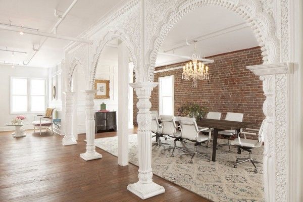 an elegant dining room with brick walls and white columns