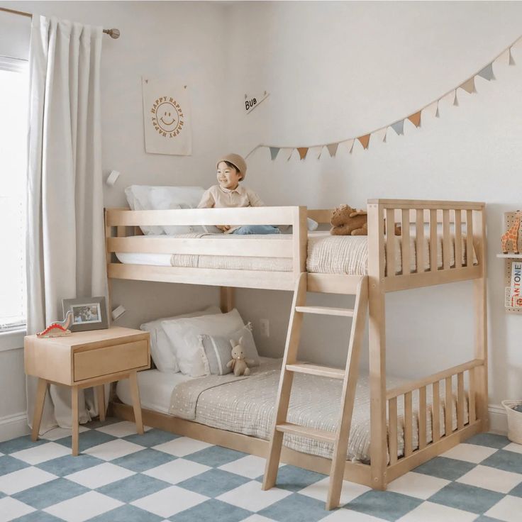 a child's bedroom with two bunk beds and a checkered floor