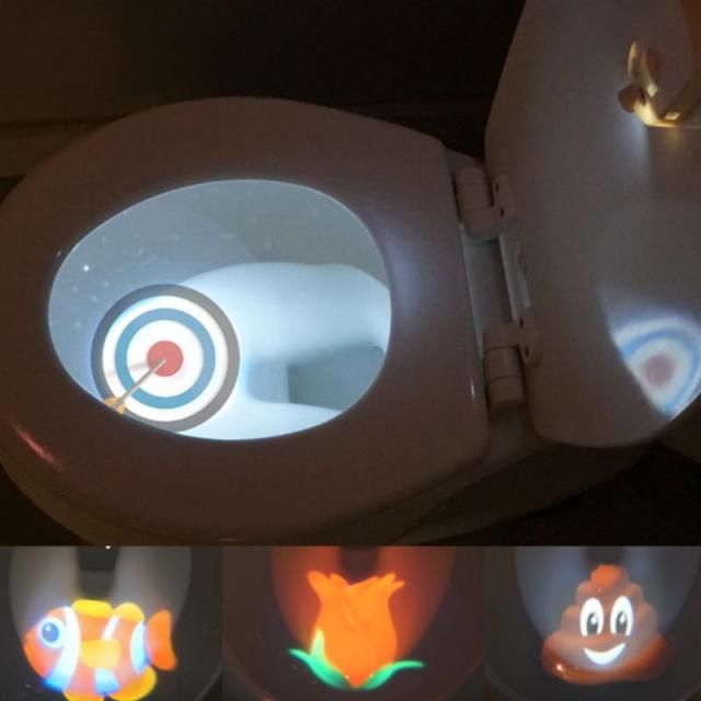 the toilet has four different colored images on it's lid and is lit up