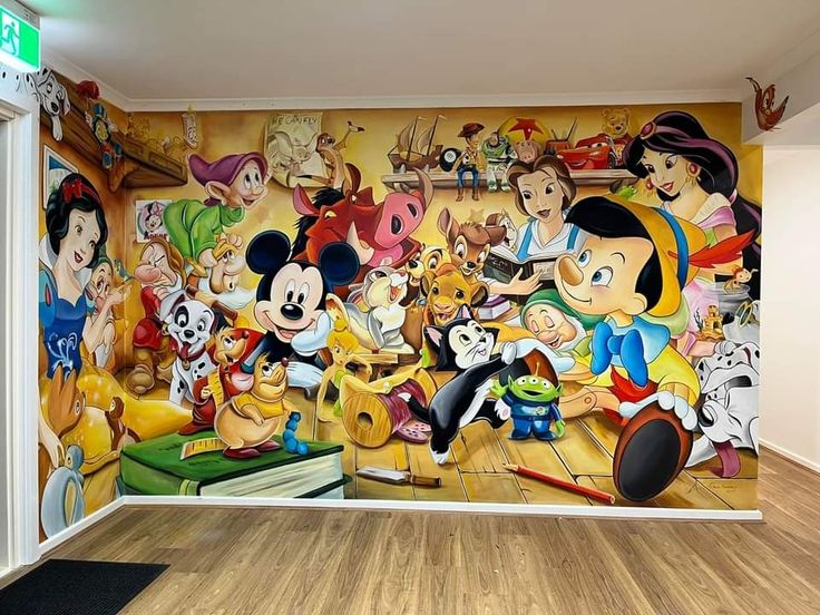 a room with a mural on the wall and mickey mouses in front of it