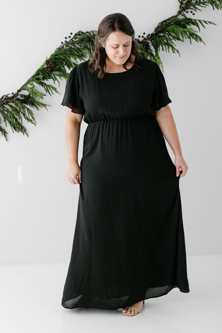 The modest formal maxi dress that you have been waiting for! The ‘Naomi’ is effortless and feminine - the perfect pick for family photos, an elegant party, or a modest bridesmaid dress. This timeless dress features a modest scoop neckline, flutter sleeves, and a chiffon overlay. The lightly gathered elastic waist and zipper closure allow for ease of styling and a flattering fit. This dress is fully lined - no layering required! Exclusively designed with you in mind. Self & Lining 100% Polyester Modest Flowy Floor-length Maxi Dress, Flowy Modest Floor-length Maxi Dress, Modest Chiffon Maxi Dress, Modest Chiffon Dress For Formal Occasions, Modest Chiffon Maxi Dress For Party, Modest Chiffon Maxi Dress For Formal Occasions, Modest Black Flowy Maxi Dress, Modest Floor-length Maxi Dress For Formal Occasions, Black Flowy Maxi Dress Modest Style