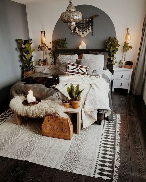 a bed room with a neatly made bed and lots of lights on the wall above it