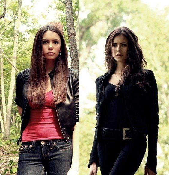 two women in black and red outfits standing next to each other, one wearing a leather jacket