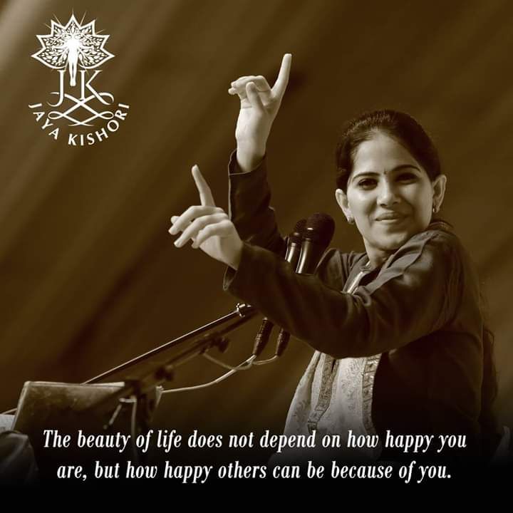 a woman giving a peace sign while standing in front of a microphone with the words