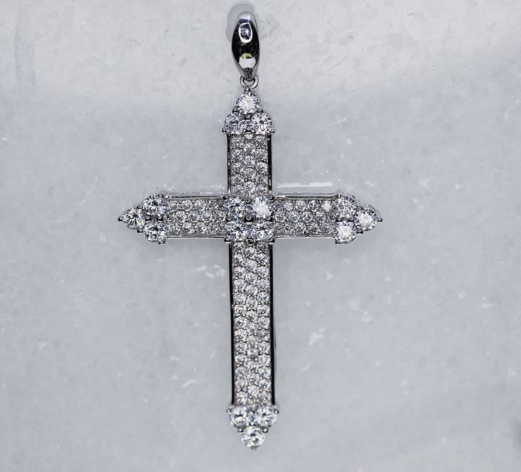 This exquisite 18K White Gold Cross Pendant effortlessly radiates elegance and luxury. Crafted from gleaming white gold and embellished with pointed tips for added refinement, it is the perfect piece of jewelry to add a touch of sophistication to any outfit. Luxury White Diamond Accents Cross Necklace, Luxury Diamond White Brilliant Cut Cross Necklace, Luxury Diamond White Crucifix Jewelry, Luxury Diamond White Elegant Cross Necklace, Luxury White Gold Cross Necklace Gift, Luxury Single Cut Diamond Cross Jewelry, Luxury White Diamond Cross Necklace, Luxury White Cross Necklace With Diamond Accents, Luxury Classic Diamond White Cross Necklace