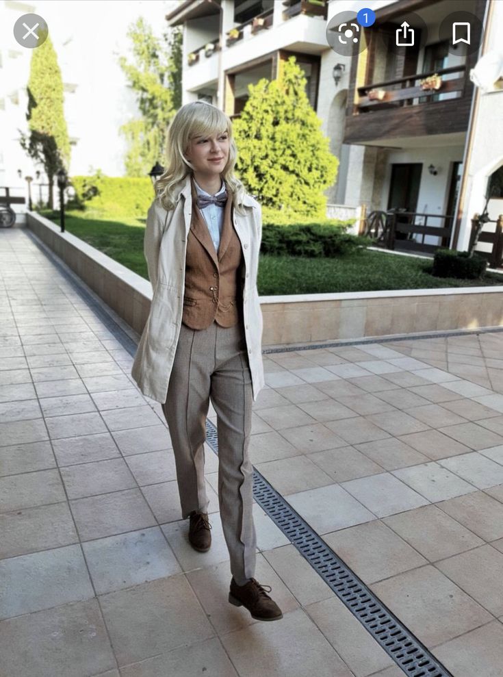 a man in a suit and tie walking down a sidewalk