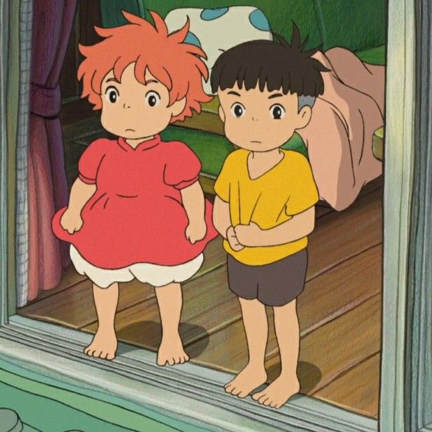 two young children standing in front of a mirror