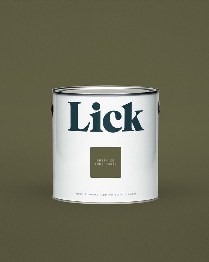 a white paint can with the word lick on it's side and a black background