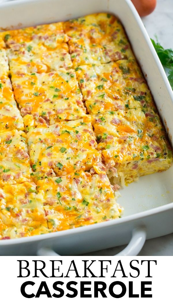 breakfast casserole with ham and cheese in a white baking dish