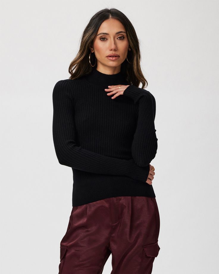 This black long sleeve high neck top is made from an incredibly soft and comfortable ribbed knit material with a flattering stitch detail at the waistline. Pair the Raisa Top with any shade of denim in your closet. Black Turtleneck With Ribbed Cuffs For Work, Chic Turtleneck With Ribbed High Neck, Black Stretch Turtleneck In Fine Knit, Black Stretch Fine Knit Turtleneck, Chic Ribbed Collar Turtleneck For Fall, Black Stretch Turtleneck With Fine Knit, Chic Turtleneck With Ribbed Cuffs For Layering, Fall Mock Neck Long Sleeve Top In Fine Knit, Fall Mock Neck Long Sleeve Fine Knit Top