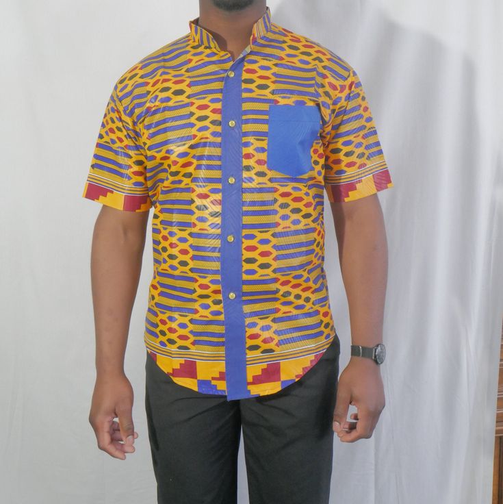 Smart and stylish African shirt, short sleeve, regular fit, button down closure with collar, perfectly tailored, neat stitching. Bold Kente/Ankara print lightweight, cotton/ polyester blend Wear casual with a pair of jeans or dress pants. Machine wash/hand wash cold with similar colors, tumble dry low or hang to dry, med iron for best results. May re-starch for a crisper look. Do not bleach. Colors may vary slightly due to pixel settings. We strive to present our products as accurate as possible Traditional Fitted Multicolor Shirt, Traditional Multicolor Fitted Shirt, Fitted Traditional Multicolor Shirt, Fitted Multicolor Traditional Shirt, Traditional Fitted Printed Shirt, Casual Fitted Shirt With Geometric Pattern, Fitted Multicolor Short Sleeve Shirt, Short Sleeve Cotton Shirt With Geometric Pattern, Fitted Short Sleeve Printed Button-up Shirt