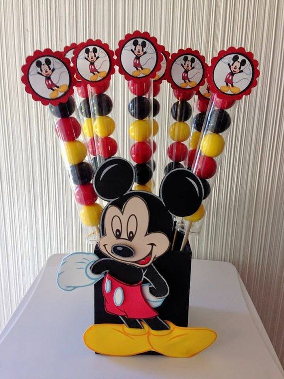 a mickey mouse centerpiece with lollipops in it