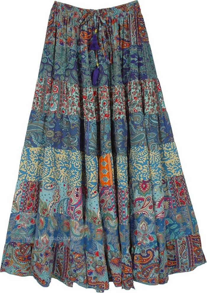 A beautiful multi-panel long skirt with a good fall and floral blue prints. The skirt has an elastic waist with a tassel drawstring. #tlb #Patchwork #MaxiSkirt #Printed #TieredSkirt #Summerskirt Blue Patchwork Maxi Skirt For Spring, Blue Maxi Skirt For Festivals, Hippie Blue Skirt For Spring, Blue Bohemian Long Skirt, Bohemian Skirt With Tassels, Traditional Blue Maxi Skirt, Traditional Blue Flowy Maxi Skirt, Blue Floral Print Tiered Maxi Skirt, Blue Flowy Maxi Skirt For Festivals