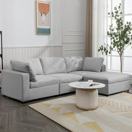 a living room with a sectional couch and coffee table