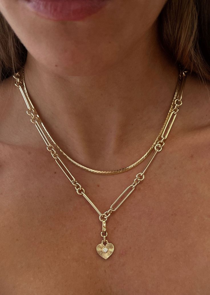 This necklace blends classic rolo links with modern paperclip links, resulting in a distinct and eye-catching silhouette. It serves as an ideal canvas for showcasing your favorite charm pendants. Lightweight and versatile—style with a tennis necklace for a luxury stack. 14k solid gold—always Average weight: 8.5g Link Dimensions: 5mm x 22mm Hollow links Lobster clasp closure Neckless Stack, Gold Necklace Stack Aesthetic, Necklace Stack, Stackable Necklaces, Gold Link Necklace, Fall Rings, Trending Necklaces, Stacked Necklaces, Star Pendant Necklace