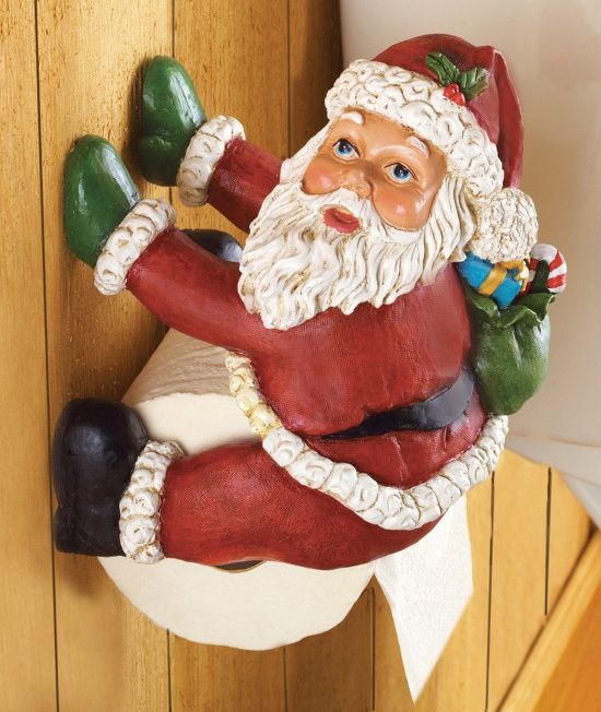 a santa clause figurine hanging from the side of a door handle on a wood paneled wall