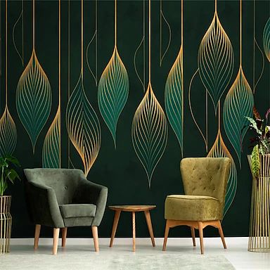 two chairs and a table in front of a green wall with gold leaves on it