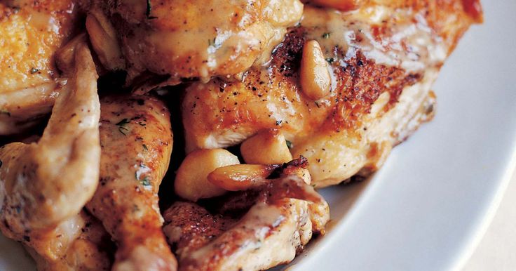 some chicken and beans on a white plate