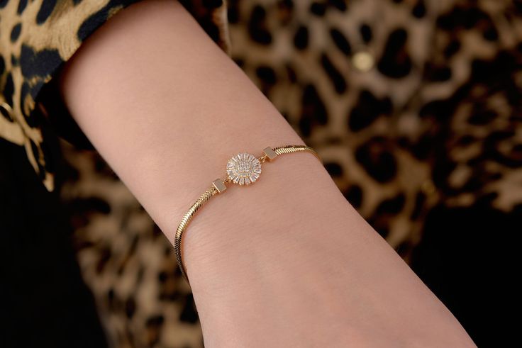 Our sunflower zircon bracelet is 14k solid gold. The zircon stones that shaped like sunflower is very charming. It can accompany you at any time of the day with dainty and minimalist style. When you think of it as a gift, it is a dainty bracelet that will make your loved ones happy on their birthday, valentine's day, mother's day, anniversary, or graduation.  Sunflower bracelet length is 6.88 inches / 17.50 cm. Its legth can get longer to 7.67 inches / 19.50 cm with its hoops. Also, you can adju Minimalist Gold Cubic Zirconia Bangle Bracelet, Dainty Cubic Zirconia Diamond Bangle Bracelet, Minimalist Cubic Zirconia Bangle Jewelry, Fine Jewelry Diamond Crystal Bracelet For Gift, Fine Jewelry Diamond Crystal Bracelet Gift, Dainty Rose Gold-plated Diamond Bracelet, Gold Plated Diamond Bracelet With Accents, Rose Gold Cubic Zirconia Bracelet With Tarnish Resistance, Dainty Gold Plated Tennis Bracelet As A Gift