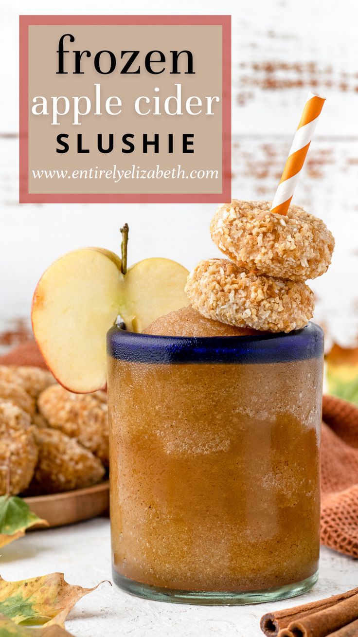 an apple cider slushie in a mason jar with cinnamon sticks and apples