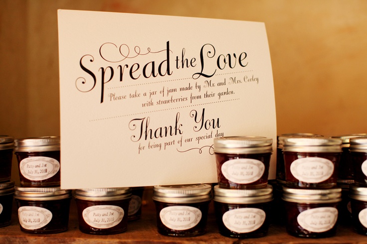 jars of jams are lined up next to a sign that says spread the love