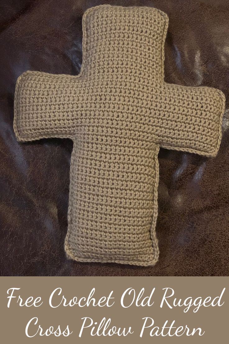 a crocheted cross pillow sitting on top of a brown leather couch with the text free crochet old rugged cross pillow pattern