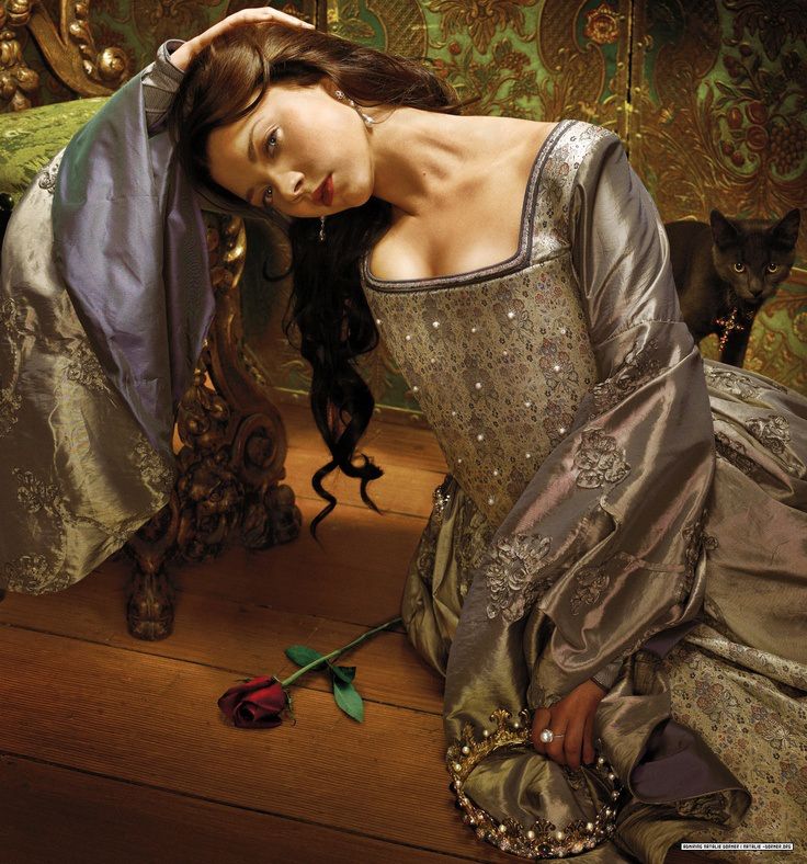 a woman is sitting on the floor in a dress