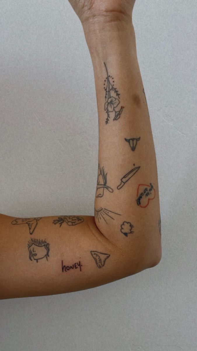 a woman's arm with tattoos on it