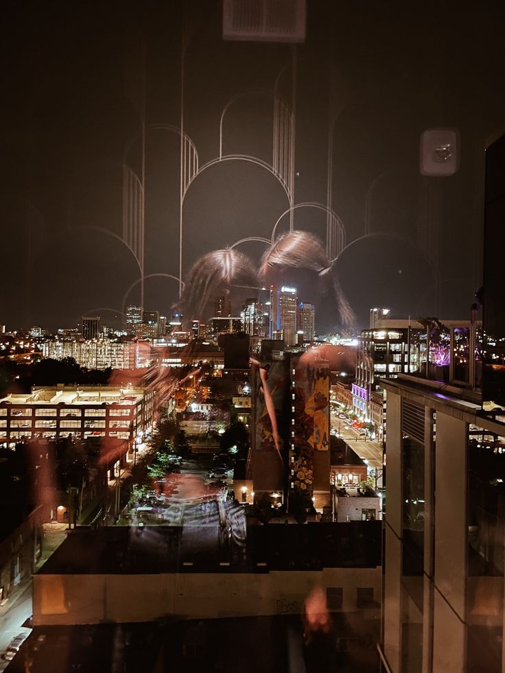 fireworks are lit up in the night sky over a cityscape with skyscrapers