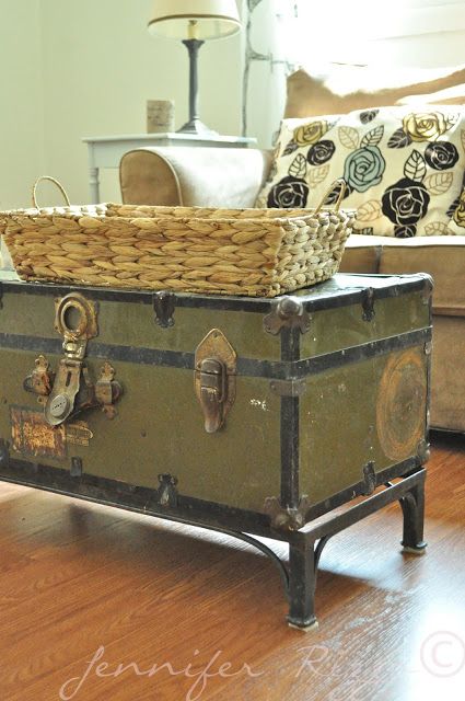 an old trunk has been converted into a coffee table with wicker baskets on top