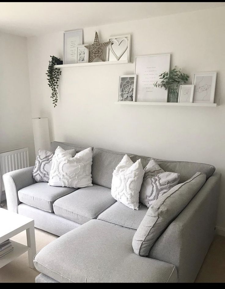 a living room filled with lots of furniture and pictures on the wall above it's couch