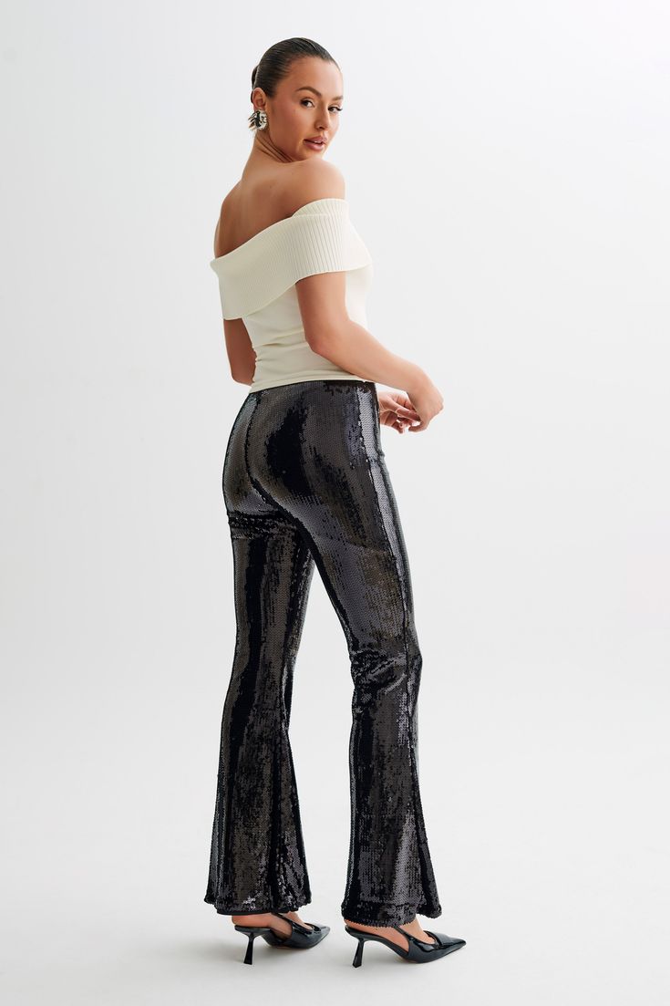 Zero disco ball required.The WILMA are a pair of sparkling wide-legged pants with a high waistline and flared hems. An invisible zipper closure at the side seam gives it a sleek, seamless silhouette. The legs transition into a flattering bootcut that complements its high, fitted waist. Lined sequinned fabrication adds a touch of comfortable glam, making these pants the perfect choice for all-night wear. Black Sequin Pants, Sequin Pants, Night Wear, Disco Ball, Black Bodysuit, Invisible Zipper, Black Heels, Nightwear, Latest Fashion Trends